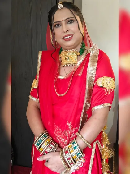 I created this complete Rajasthani look for a client attending a cultural event. The makeup was designed to complement the traditional red attire and heavy gold jewelry, featuring a bold lip and defined eyes.