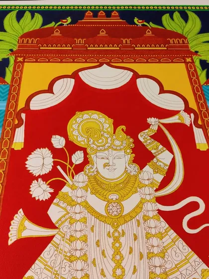 The Srinathji painting with the first layers of color, showing the vibrant red and yellow.