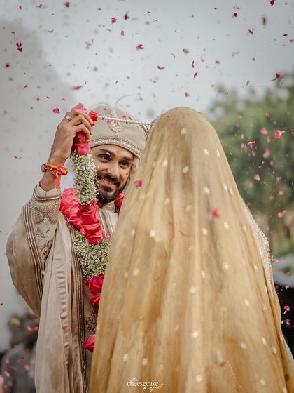 A beautiful over-the-shoulder shot of the groom during the Varmala.