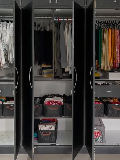 This is the result of a complete wardrobe system overhaul. We created specific zones for hanging clothes, sarees, and folded items in storage bins, ensuring every single item has a designated home. This is what a stress-free morning looks like.