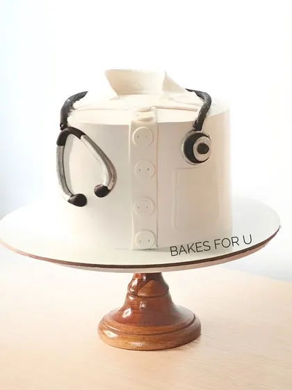 "Congratulations Dr. Aditya." A simple and elegant cake designed to look like a doctor's coat with a stethoscope. A perfect way to celebrate a medical school graduation or achievement.