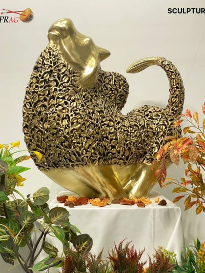 A magnificent brass sculpture of a seated animal, its body created from an intricate lattice of leaves, blending strength with delicate craftsmanship.