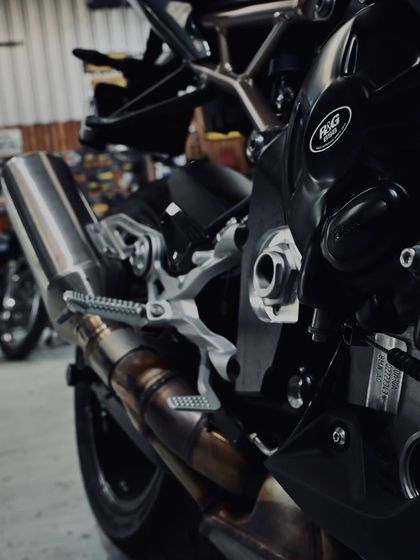 A view of the rearset and exhaust on the S1000RR, showing its race-bred design.
