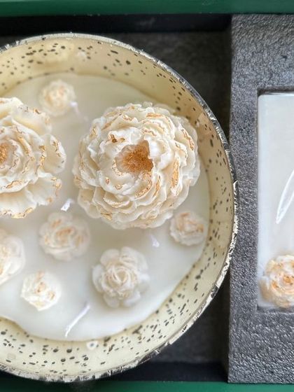 A top-down view of the Peony Candle Gift Box, showing the hand-painted peony wax flowers floating in the bowl candle alongside the matching wax tablet.
