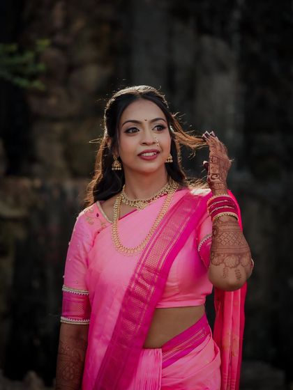 A lovely candid of the bride as a gentle breeze catches her hair. Her natural smile and the outdoor setting create a fresh and beautiful engagement portrait.