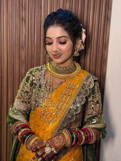 A close-up of the bride's soft, glowing makeup and traditional jewellery.