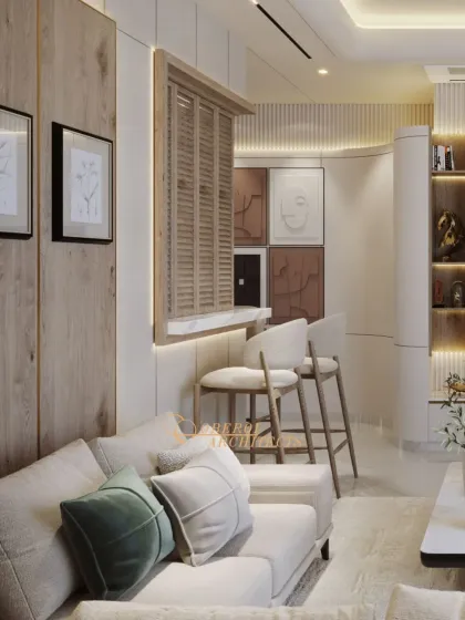 This view shows the connection between the living area and a pass-through bar, creating an open and social atmosphere. The mix of wood, soft fabrics, and subtle art creates a cohesive and warm environment.