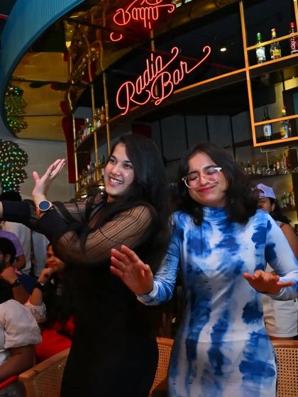 Two friends showing off their dance moves. At Let's Jam, there's no such thing as a "dance floor", the whole place is a dance floor.