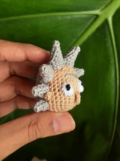 A side view of the Rick amigurumi shows the spiky hair detail from another angle. Each spike is individually crocheted and attached.