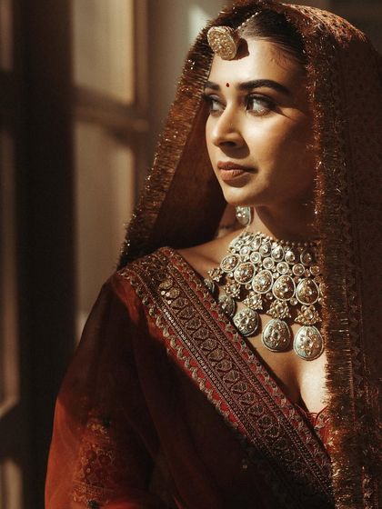 It’s all in the details. A close-up of Nilofer's rustic orange Sabyasachi wedding look, highlighting her stunning silver jewelry.