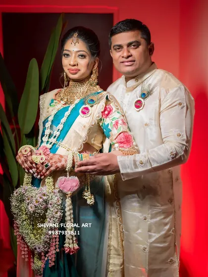 A beautiful couple at their baby shower. I designed the mom-to-be's jewellery and the unique heart-shaped floral hand prop she is holding.