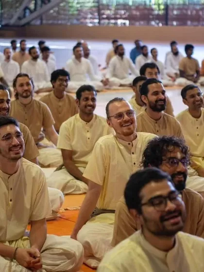 The faces of fellow participants, filled with joy and laughter, during a session with Sadhguru. The training fosters a strong sense of community and shared purpose.