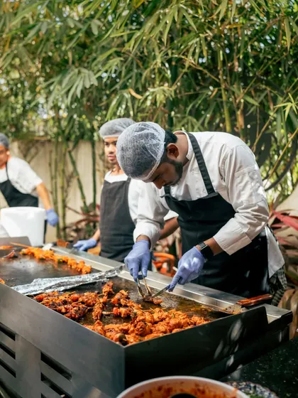 Behind the scenes at an event, where my chefs work over the grill to prepare delicious food for our guests.
