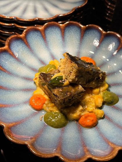 Another angle of our colourful and artistic entree, showcasing the beautiful, handcrafted ceramic plate that enhances the presentation.