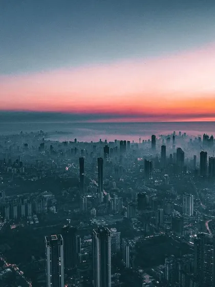 A wide aerial shot of Mumbai, with a dramatic edit that casts the entire city in a dark, moody, and cinematic light.