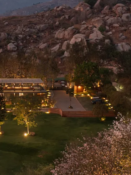 As dusk settles, 'The Earth' project integrates into the rocky terrain of the Nandi Hills. Our landscape lighting design is intentionally soft, tracing pathways and uplighting trees to create a gentle glow that respects the darkness of the natural environment.