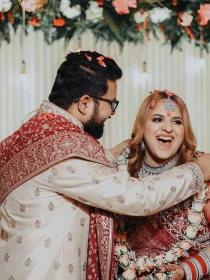 A beautiful, happy moment between the couple, showered with flower petals. These are the joyful memories that make a wedding album special.