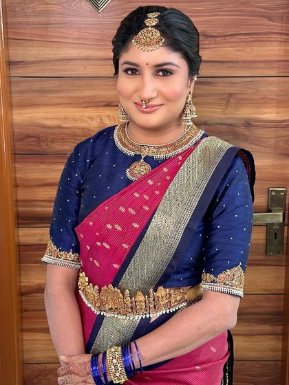 A close-up portrait focusing on the intricate gold jewellery and flawless makeup.