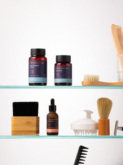 This organized shelf setup showcases a complete men's grooming and wellness routine. The mix of products and tools, like combs and brushes, tells a story of self-care and attention to detail.
