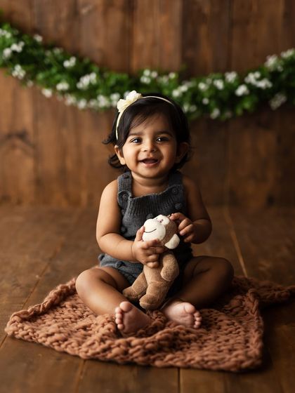 A happy smile while holding a little monkey friend. I always have gentle, baby-safe toys on hand to help them feel comfortable and engaged.