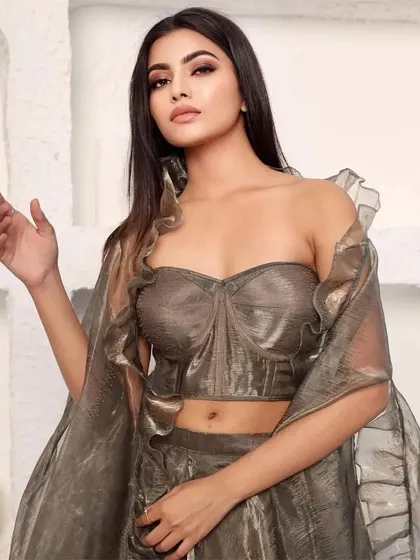 A close-up of the model in the metallic organza lehenga, showing the texture of the fabric.