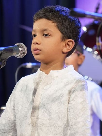 One of our youngest vocal students, focused and confident at the microphone.