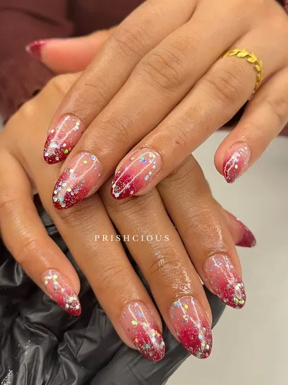 Ombré plus glitter equals nail perfection. This design features a beautiful red-to-nude ombré with a cascade of holographic glitter for ultimate sparkle.