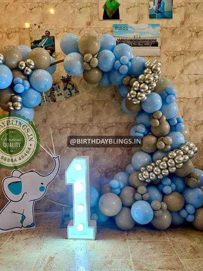 Another view of the blue and grey elephant balloon arch, showing how it can frame a space for photos or a cake table.