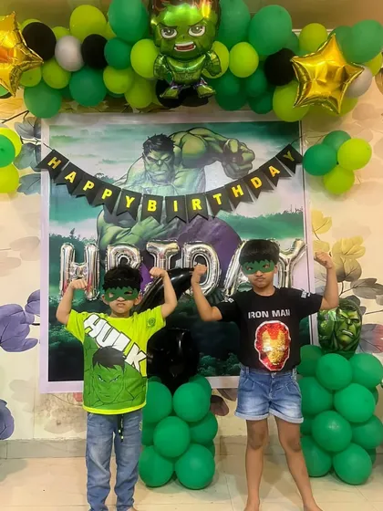 Look at these little superheroes enjoying their Hulk-themed birthday party. I created a full backdrop with a custom Hulk poster, a green and black balloon garland, and character foil balloons. Seeing the kids so happy and engaged with the decor is the best part of my job.