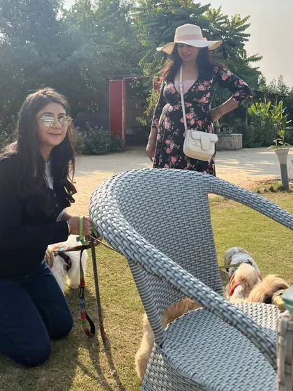 Guests enjoying a walk and playtime with their dogs on our spacious lawns. It's a great environment for both people and pets.