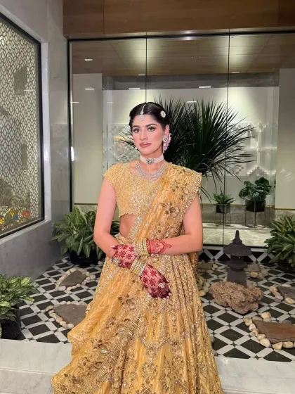 A beautiful shot of the bride in a modern setting. The golden lehenga I styled stands out against the contemporary background, showing its versatility.