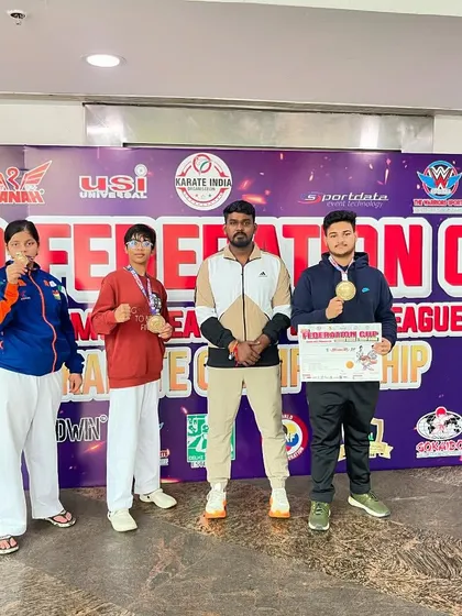 Standing with my medal-winning students at the KIO Federation Cup. My focus is on preparing each athlete to reach their highest potential.