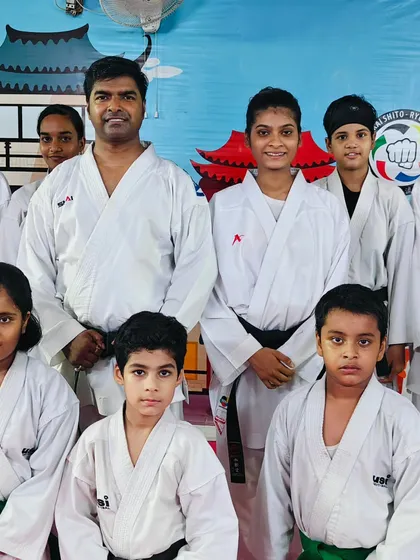 A group photo with students of various belt levels, from green to black. It shows the path of progression at our academy.