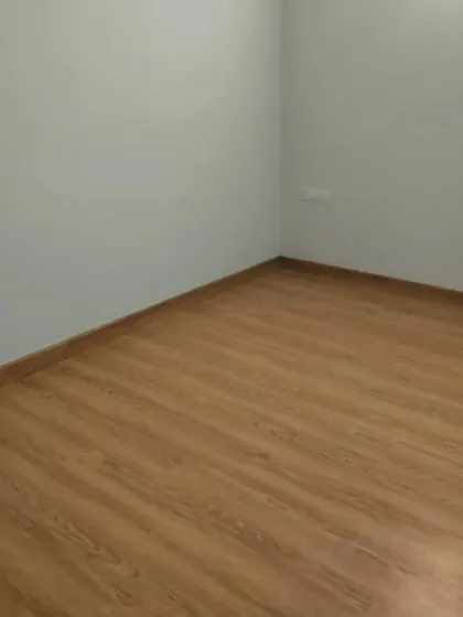 This room showcases a cool, light grey wall colour paired with a wooden floor. This combination creates a modern and calming atmosphere, suitable for a bedroom or study.
