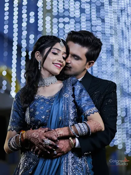 A romantic embrace against a backdrop of beautiful blue and white lights.