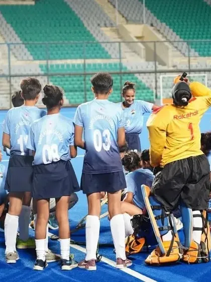 A quick strategy session with the coach during a break in play. I believe in hands on coaching, providing constant guidance and motivation to my players right on the field.
