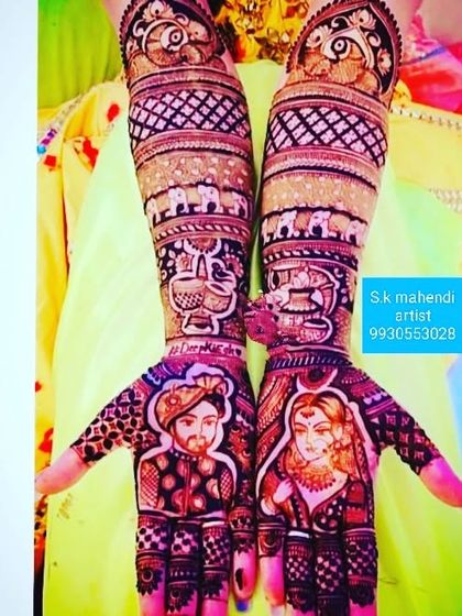 A classic portrait mehendi with a clean and balanced design. The couple's portraits are the main focus, with traditional patterns filling the arms.