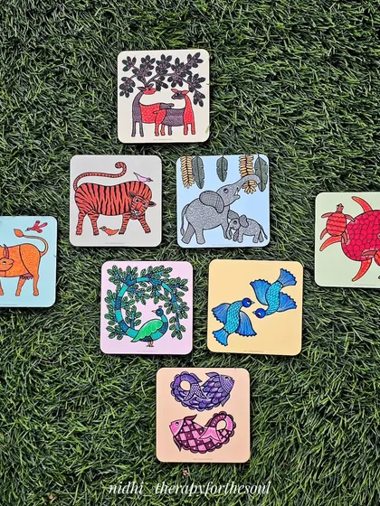 My art isn't just for walls. I create functional items like these Gond art coasters, which were part of a large bulk order for wedding favors. Each coaster features a different hand-painted animal design, making for a unique and memorable gift.