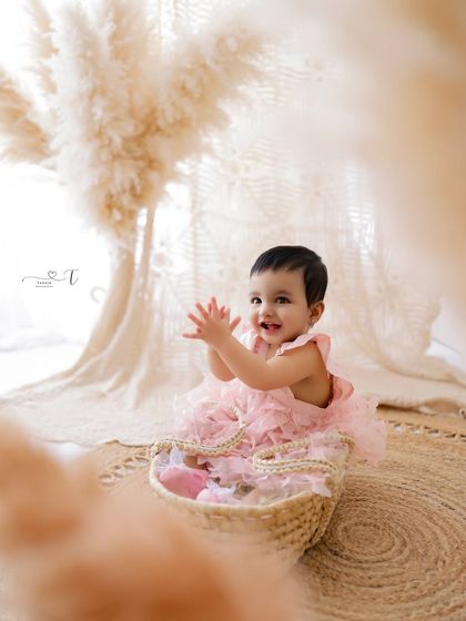Clapping for joy! This photo captures a moment of pure happiness during a first birthday milestone session.