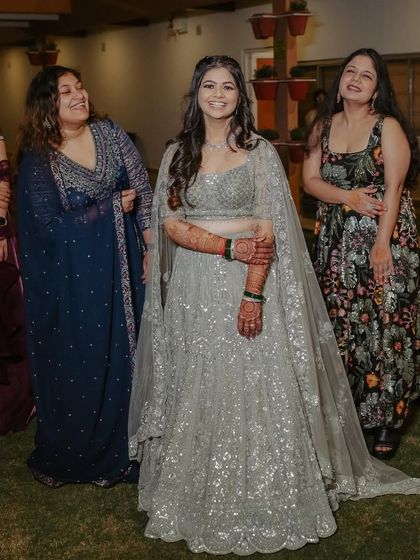 The bride surrounded by her friends and family. Her engagement look is glamorous yet understated, allowing her to shine.