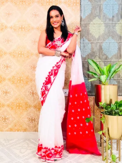 The iconic white and red Jamdani saree, a must-have for any saree lover. It's perfect for festive occasions, especially Durga Puja.