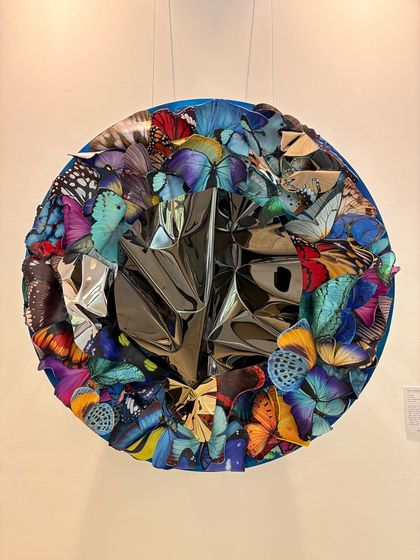 The full "Metamorphosis in Metal" wall piece, a circular composition that feels both chaotic and harmonious.