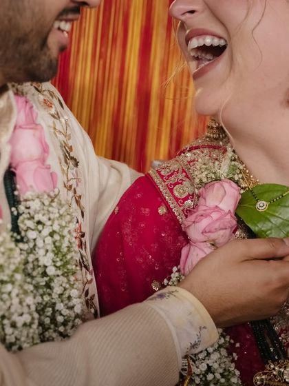 A close-up of a joyful laugh shared between the couple during their wedding ceremony. These are the authentic, candid moments that make the best memories.