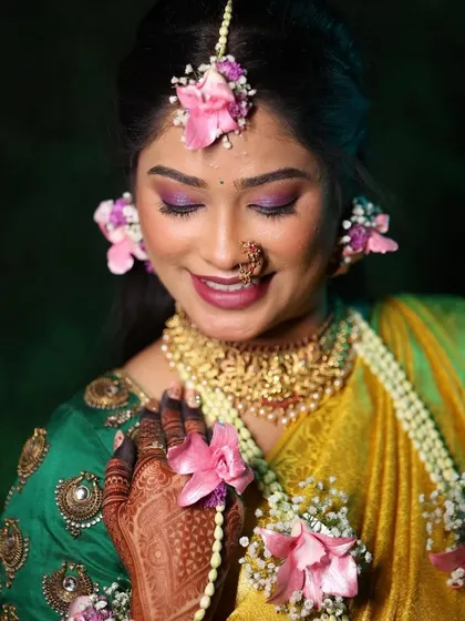 A close-up of a vibrant Haldi look. I love using fresh floral jewelry to complement the bright, joyful makeup, creating a look that is both traditional and wonderfully fresh for the ceremony.