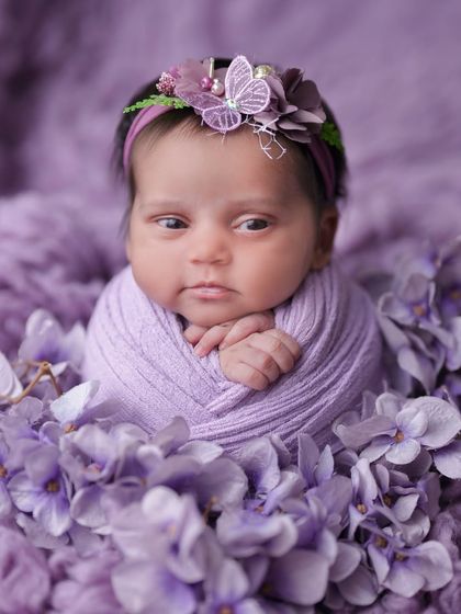 An adorable awake moment in a purple floral setting. I love capturing their curious expressions as they take in the world around them.