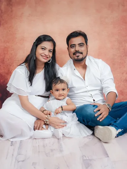 A classic seated family portrait, showing a moment of calm and togetherness.