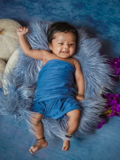 Cloud-soft snuggles and moonlight giggles. We love the contrast of deep blues and soft textures for a beautiful newborn photo.
