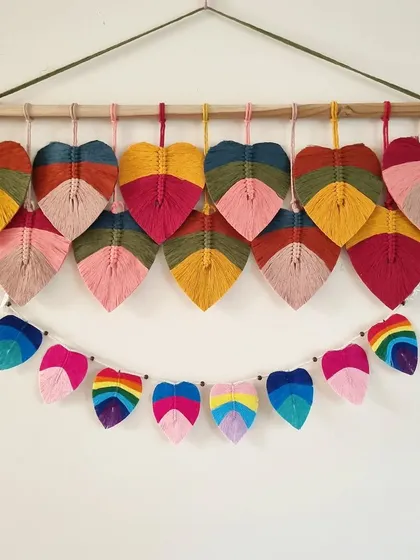 A colorful combination of our macrame leaf hanging and a matching leaf bunting. This set is perfect for decorating a nursery, a kid's room, or for a festive occasion.