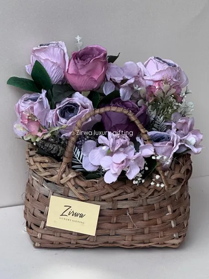 This woven basket is overflowing with a beautiful arrangement of purple and lavender flowers, showing another style of my floral basket creations.