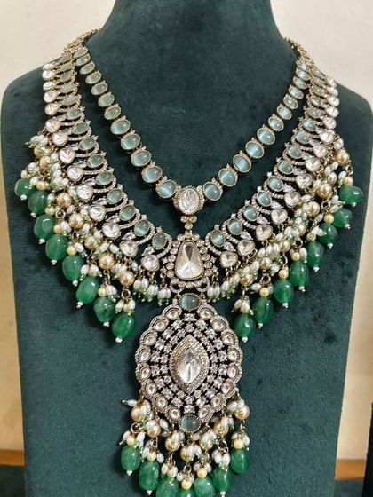 A stunning bridal necklace set with pastel green beads and heavy Kundan work. This rental piece is ideal for a bride who wants a royal look.
